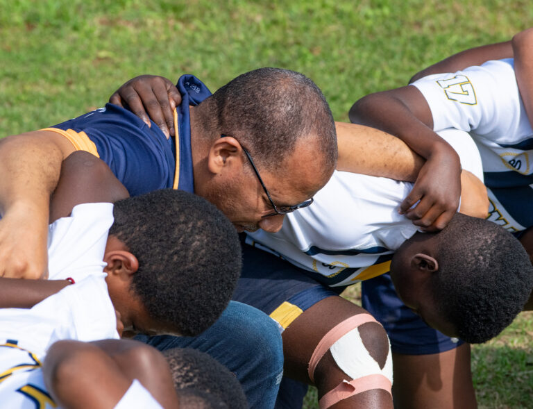 PORT NATAL HIGH SCHOOL HEADMASTER PRAYS WITH STUDENTS BEFORE RUGBY MATCH